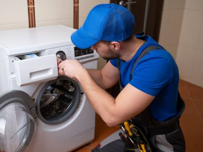 Technician repairing a washing machine